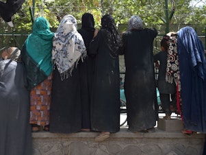 caption: Internally displaced Afghan women, who fled because of battling between the Taliban and Afghan security forces, gather at Shahr-e-Naw Park in Kabul on Aug. 13.