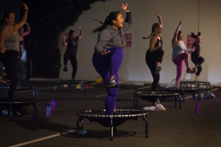 caption: Anna-Marie Lim, center, participates in an outdoor bounce and sculpt class led by Allison Axdorff, not pictured, on Tuesday, October 13, 2020, at Upbeats fitness studio along NW Leary Way in Seattle.