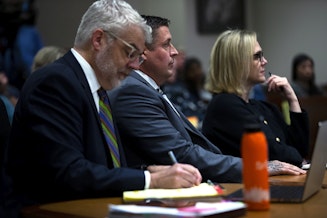 caption: Jeffrey Nelson, center, sits during his trial between his defense attorney’s Tim Leary, left, and Emma Scanlan, right, on Wednesday, May 22, 2024, at the Maleng Regional Justice Center in Kent. 