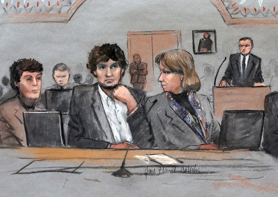 caption: In this courtroom sketch, Dzhokhar Tsarnaev, center, is depicted between defense attorneys Miriam Conrad, left, and Judy Clarke, right, during his federal death penalty trial.