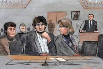 caption: In this courtroom sketch, Dzhokhar Tsarnaev, center, is depicted between defense attorneys Miriam Conrad, left, and Judy Clarke, right, during his federal death penalty trial.