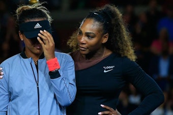 caption: Serena Williams (R) of the United States comforts Naomi Osaka (L) of Japan after Osaka won the Women's Singles finals match on Day Thirteen of the 2018 US Open at the USTA Billie Jean King National Tennis Center on September 8, 2018 in the Flushing neighborhood of the Queens borough of New York City. 