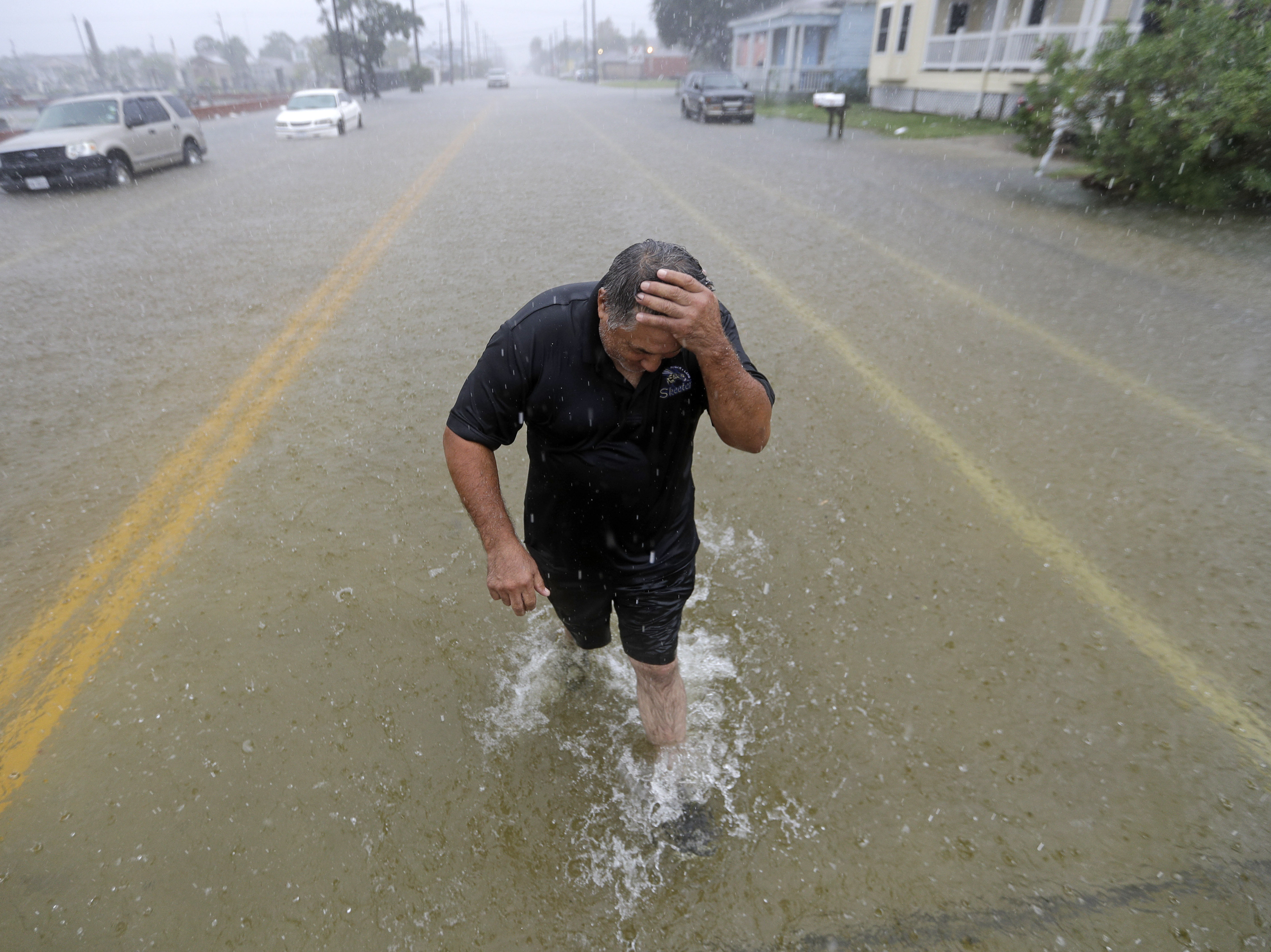 caption: Parts of eastern Texas could see nearly 3 feet of rain through Friday, forecasters say, warning of potential flash floods from Tropical Depresion Imelda. Here, Angel Marshman walks through floodwaters in Galveston after trying to start his flooded car Wednesday.