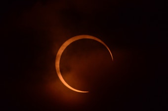 caption: 2012 annular eclipse, observed through a solar filter near Yreka, CA, partially obscured by clouds.