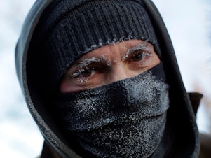 caption: Frank Lettiere's eyebrows and eyelashes froze after his walk along Lake Michigan's Chicago shoreline Wednesday. Frostbite warnings were issued for parts of the U.S. Midwest as temperatures plunged.