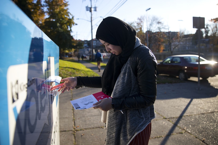 caption: Sarya Sos drops off ballots on behalf of community members on Tuesday, November 5, 2019, at the Rainier Community Center in Seattle.