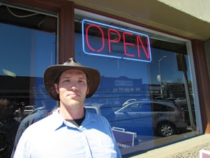 caption: Chris Cody at Herban Legends in White Center, the mostly unincorporated neighborhood just south of Seattle. The medical marijuana business recently received a letter from King County telling it to close.