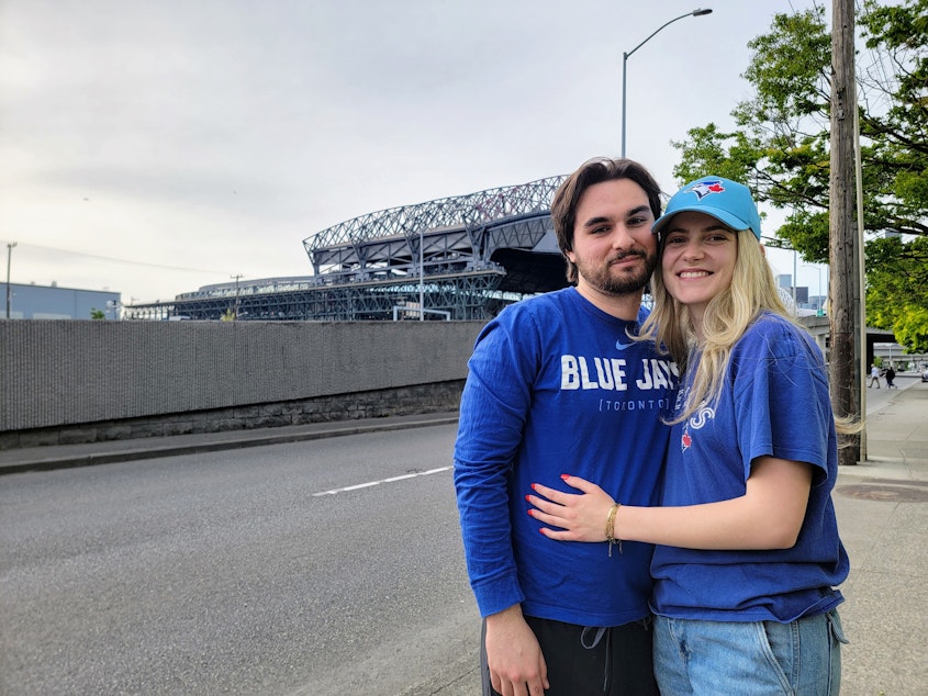 caption: Adam Menikefs and Lilah S. outside the Seattle ballpark on Friday, May 9, 2025.