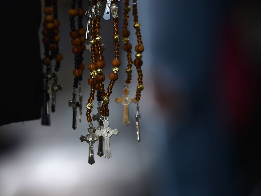 caption: Rosaries are sold by a vendor in Mexico City on Sept. 22, 2017.