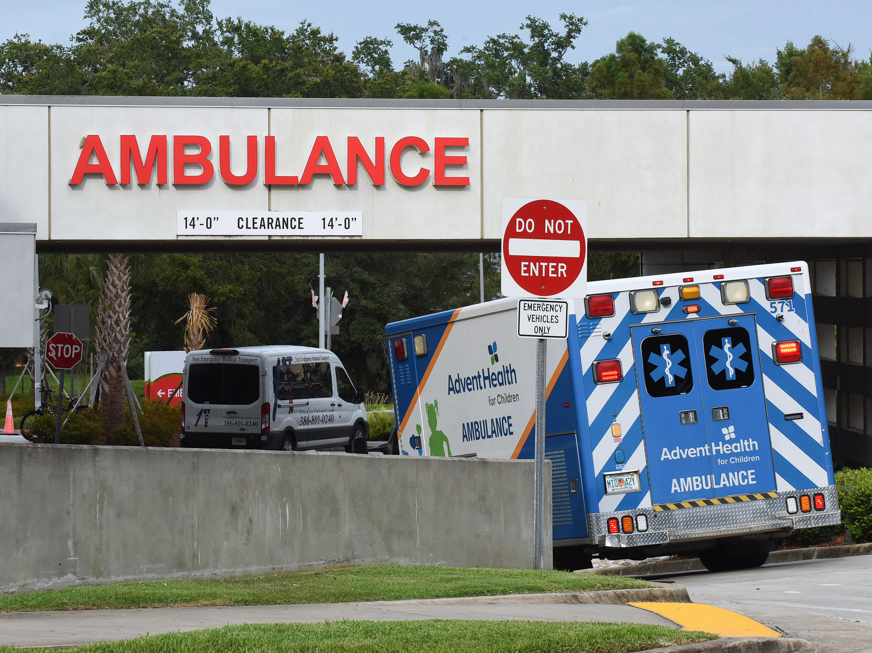 caption: An ambulance arrives at the emergency department at AdventHealth hospital in Orlando in late July. Florida is one of several states seeing disappearing hospital capacity as COVID-19 cases surge.