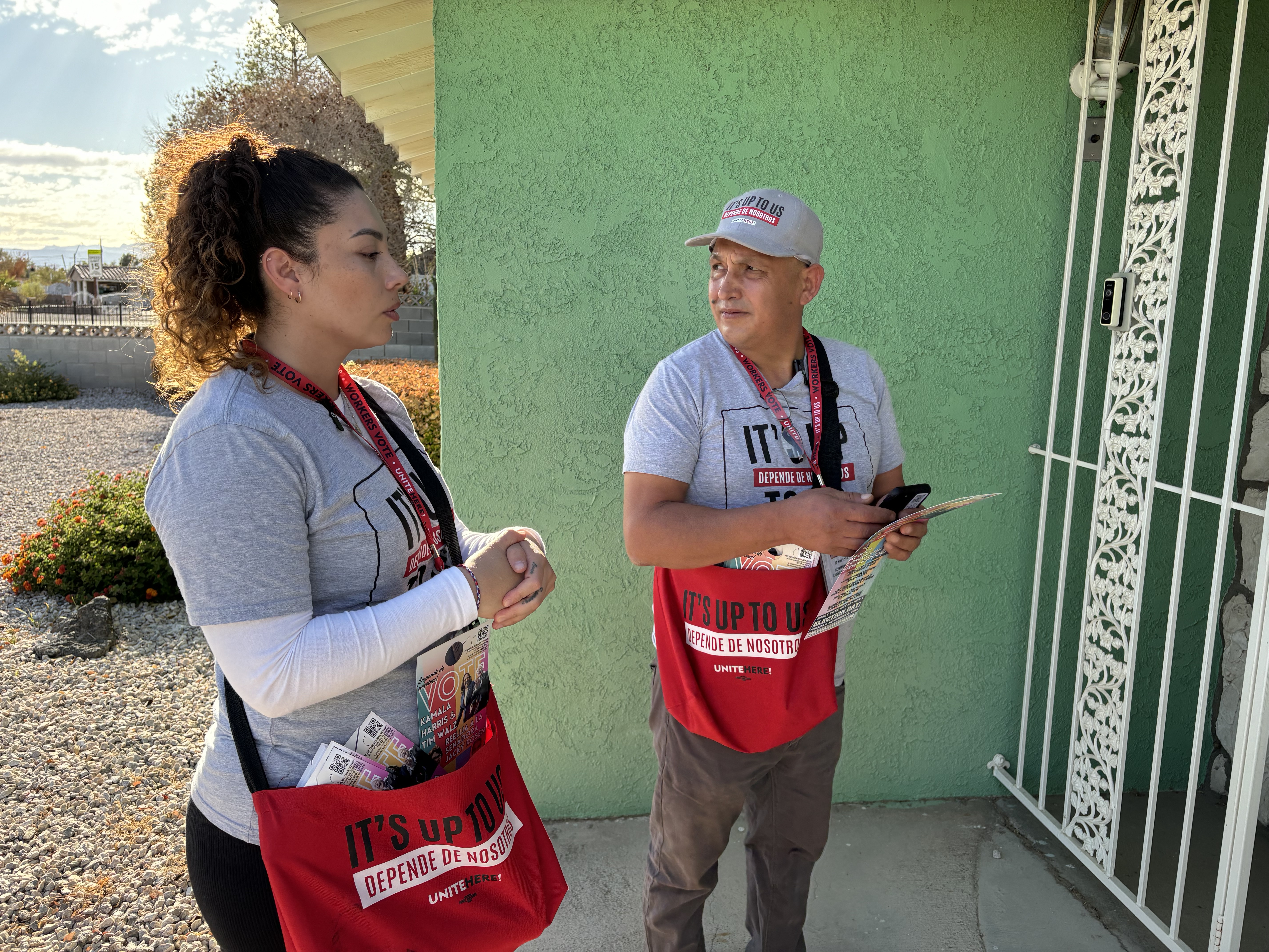 caption: Nancy Chavez Florez and Mauricio Baena, a kitchen worker and food runner, are members of the Culinary Workers Union. They have been knocking on doors in Latino and minority neighborhoods in Las Vegas in support of Vice President Kamala Harris. <br>