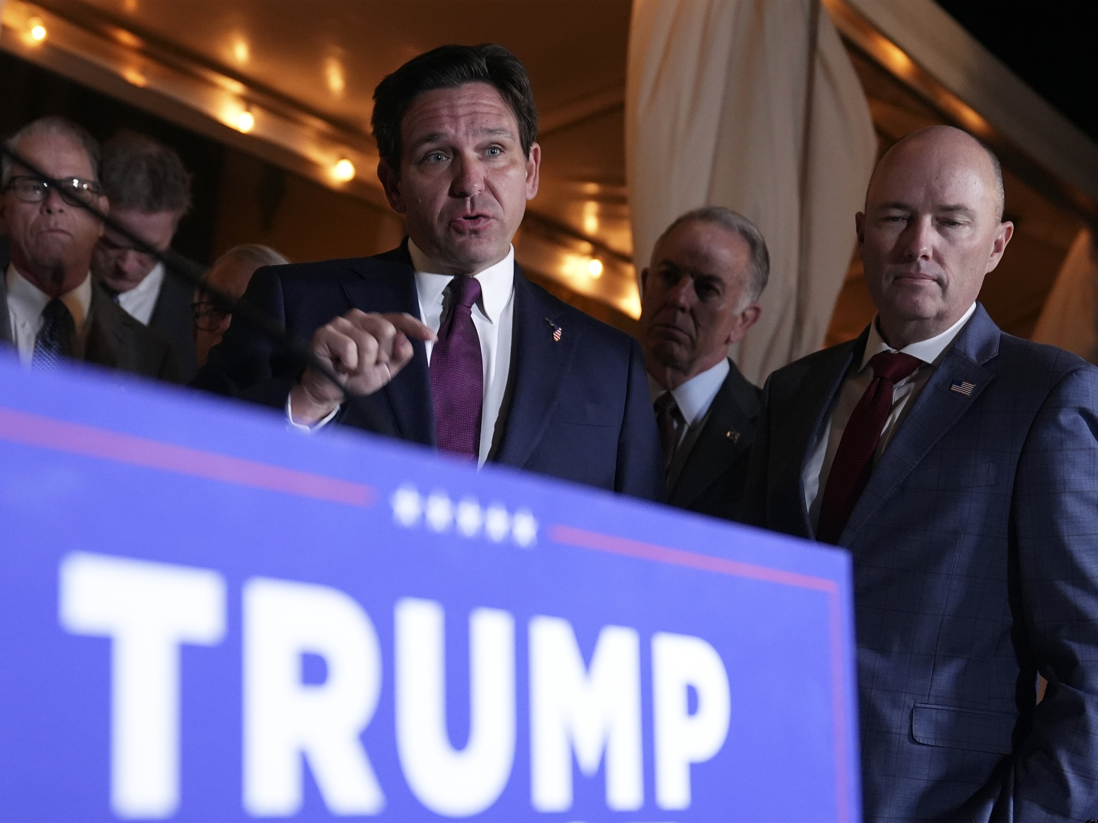 caption: Florida Gov. Ron DeSantis speaks at a meeting with other Republican governors and President-elect Donald Trump, at Mar-a-Lago, in Palm Beach earlier this month.