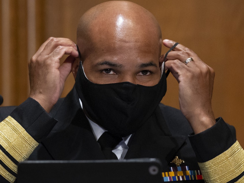 caption: Surgeon General Jerome Adams, pictured on Capitol Hill on Sept. 9, says the Trump administration coronavirus task force is sharing information with "everyone," despite claims that they are not sharing information with the Biden transition team.