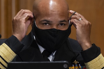 caption: Surgeon General Jerome Adams, pictured on Capitol Hill on Sept. 9, says the Trump administration coronavirus task force is sharing information with "everyone," despite claims that they are not sharing information with the Biden transition team.