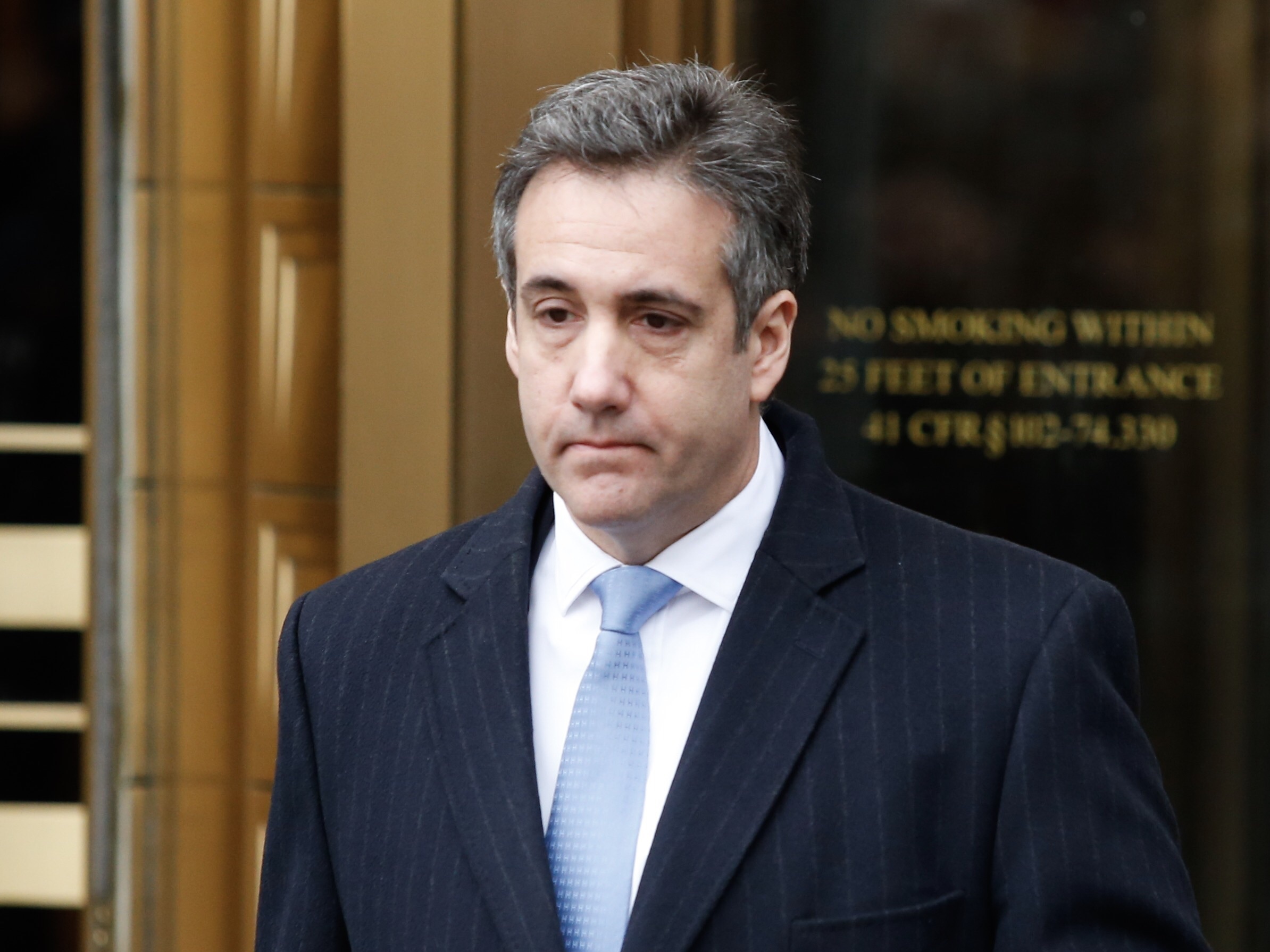 caption: Michael Cohen, President Trump's former personal attorney and fixer, exits federal court after his sentencing hearing Wednesday in New York City.