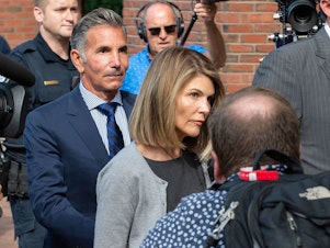 caption: Actress Lori Loughlin and husband Mossimo Giannulli exit the Boston federal courthouse after a hearing on August 27.