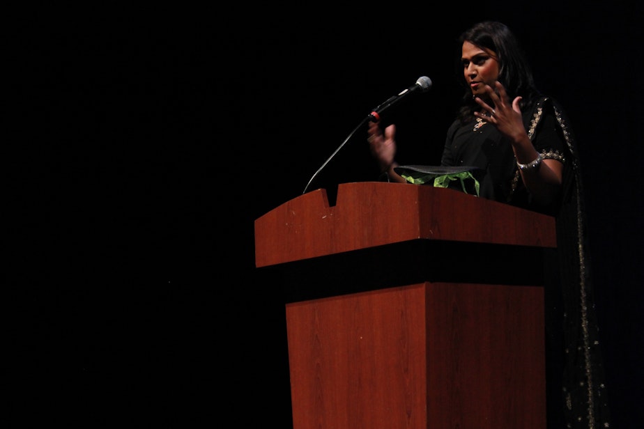 caption: Aneesh Sheth speaks at KUOW's Storywallahs event in early May at the Kirkland Performing Arts Center.
