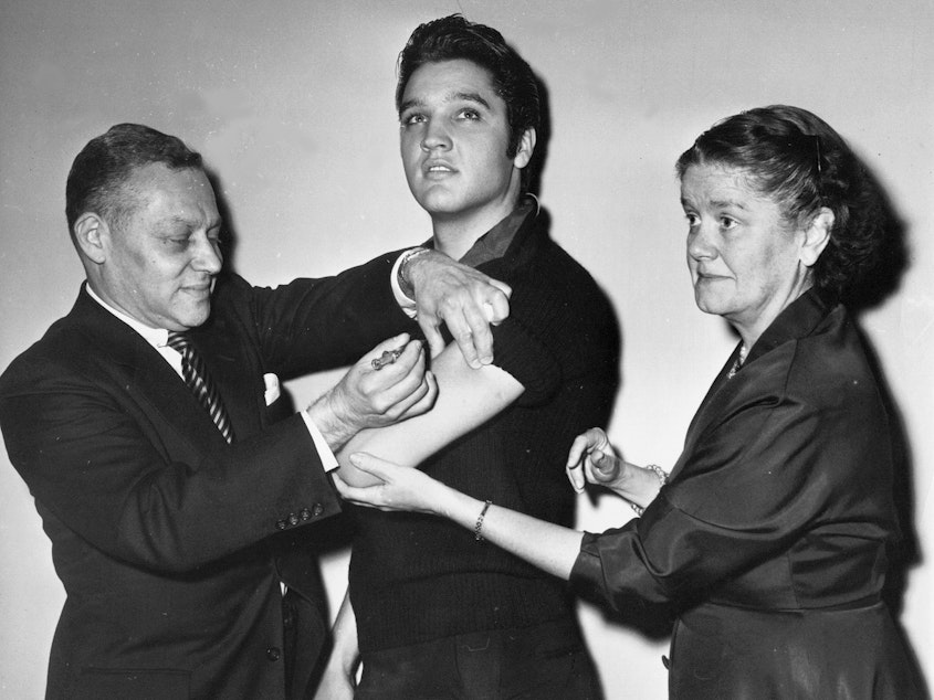 caption: Elvis Presley receives a polio vaccine in New York City in 1956 in an effort to inspire public confidence in the vaccine. The Ad Council says it will be recruiting trusted influencers for its campaign around the coronavirus vaccine.