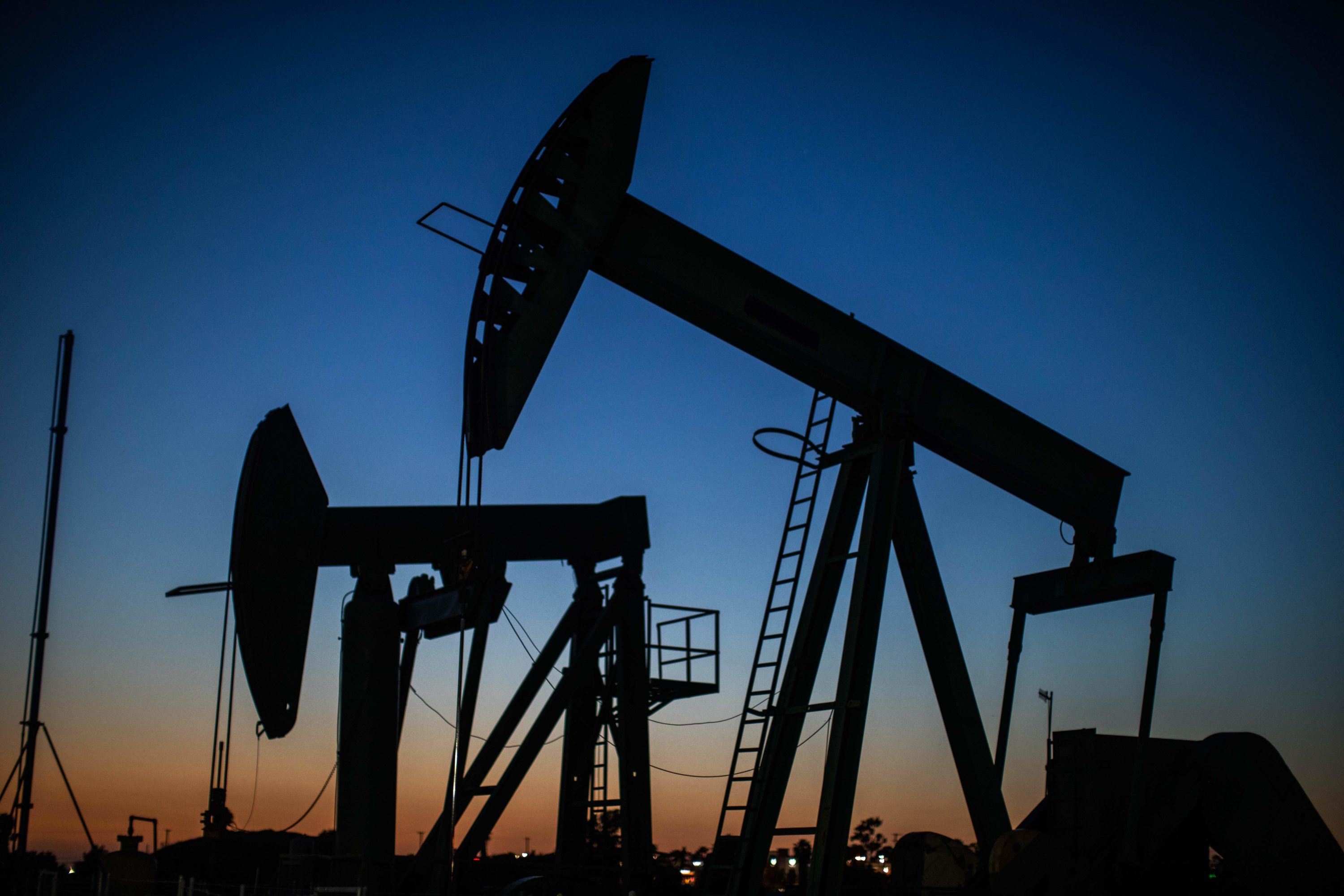 caption: Oil pumpjacks operate at dusk Willow Springs Park in Long Beach, California on April 21, 2020, a day after oil prices dropped to below zero as the oil industry suffers steep falls in benchmark crudes due to the ongoing global coronavirus pandemic. (APU GOMES/AFP via Getty Images)