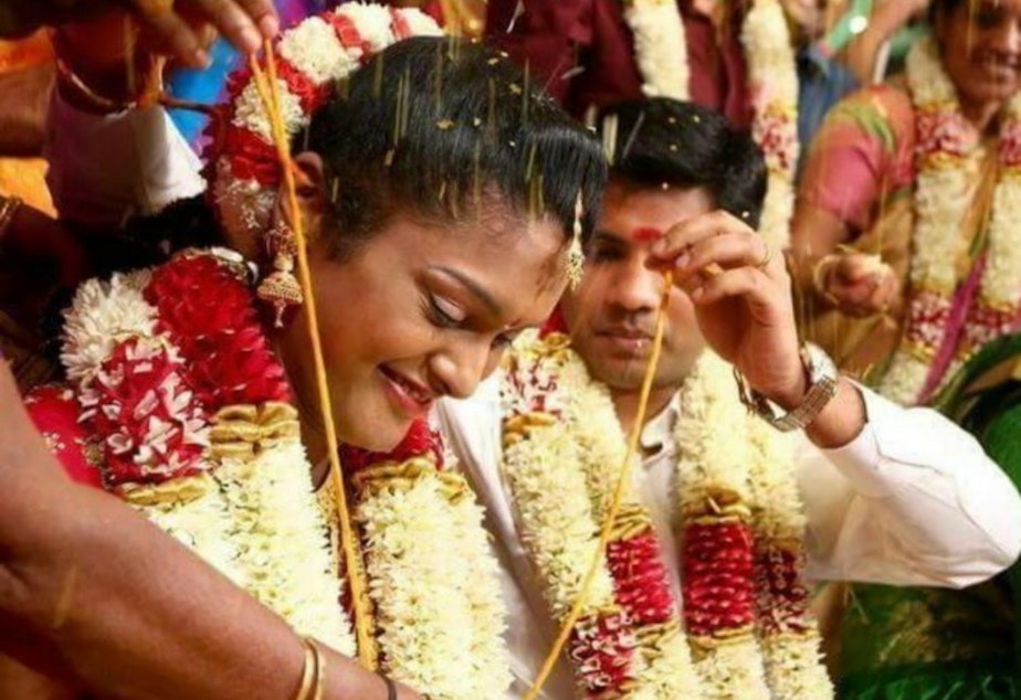 caption: Dhana Viswanathan and her husband, Balaji Viswanathan, at their wedding ceremony in Puducherry, India in 2015.