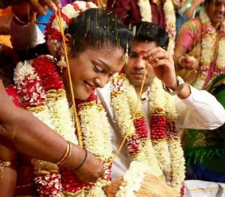 caption: Dhana Viswanathan and her husband, Balaji Viswanathan, at their wedding ceremony in Puducherry, India in 2015.