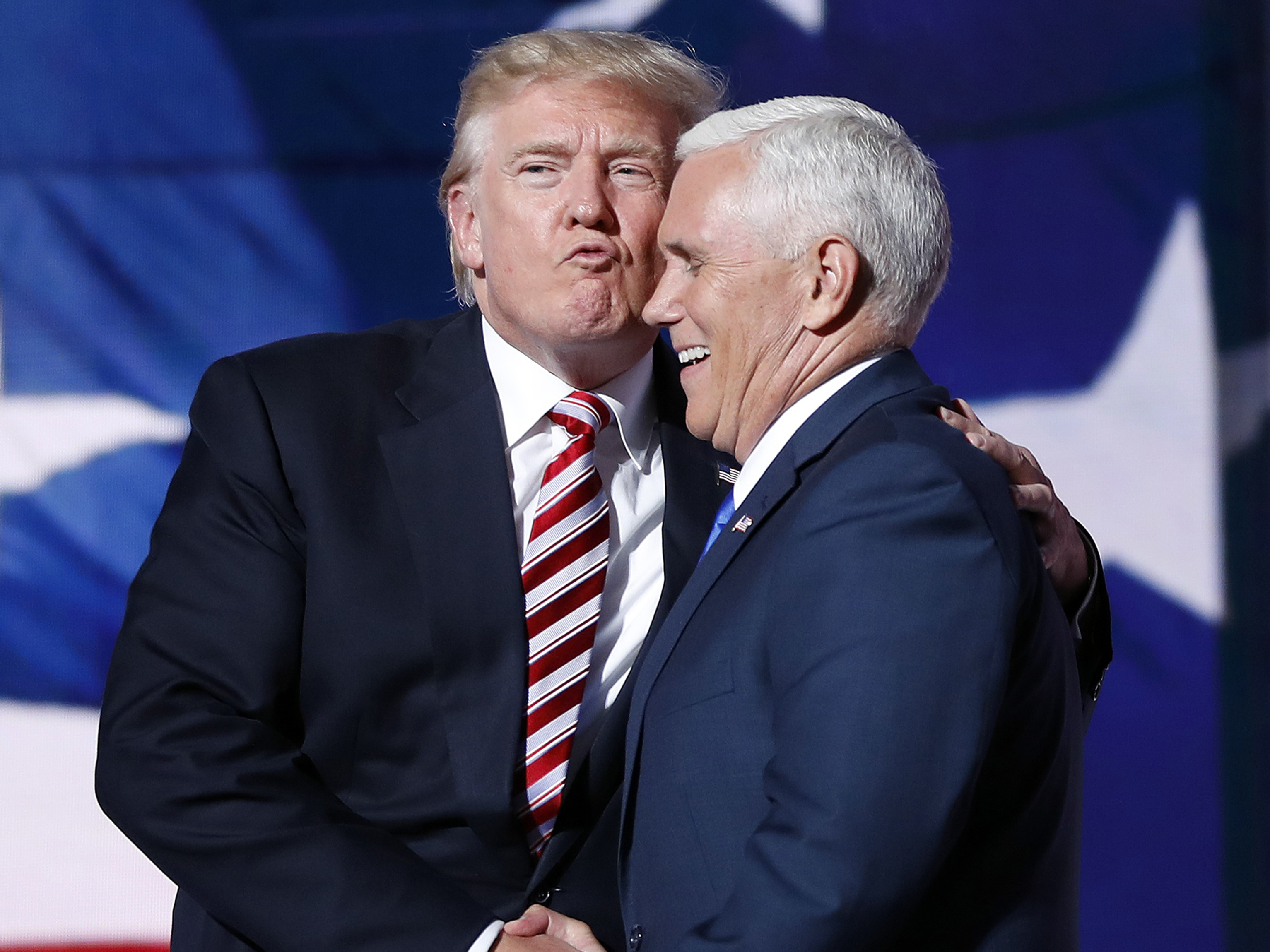 caption: Donald Trump and his then-running mate, Mike Pence, embrace as they shake hands after Pence's acceptance speech at the 2016 Republican National Convention in Cleveland.