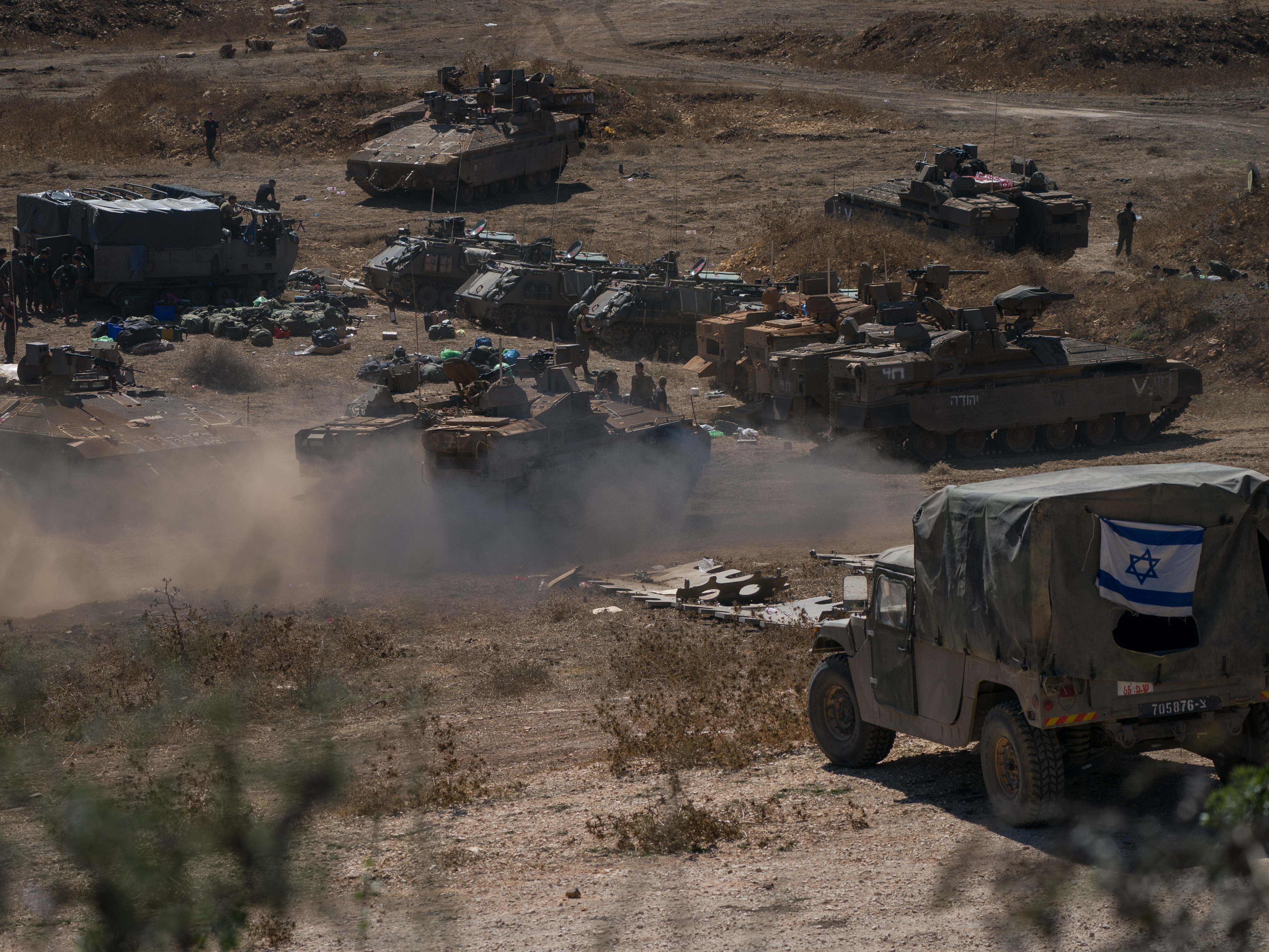 caption: Tanks and troops gather in northern Israel on Monday in preparation for a ground invasion.