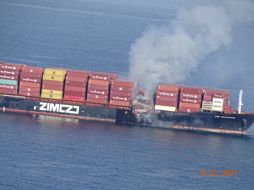 caption: Shipping containers on the M/V Zim Kingston burn in the Strait of Juan de Fuca, off Victoria, British Columbia, on Saturday.