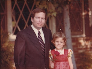 caption: Stephanie Hofeller stands with her father, Thomas, for a family photo in California during the 1970s. Republicans fought to stop computer files found on the redistricting expert's hard drives from going public — now Stephanie is sharing them online.