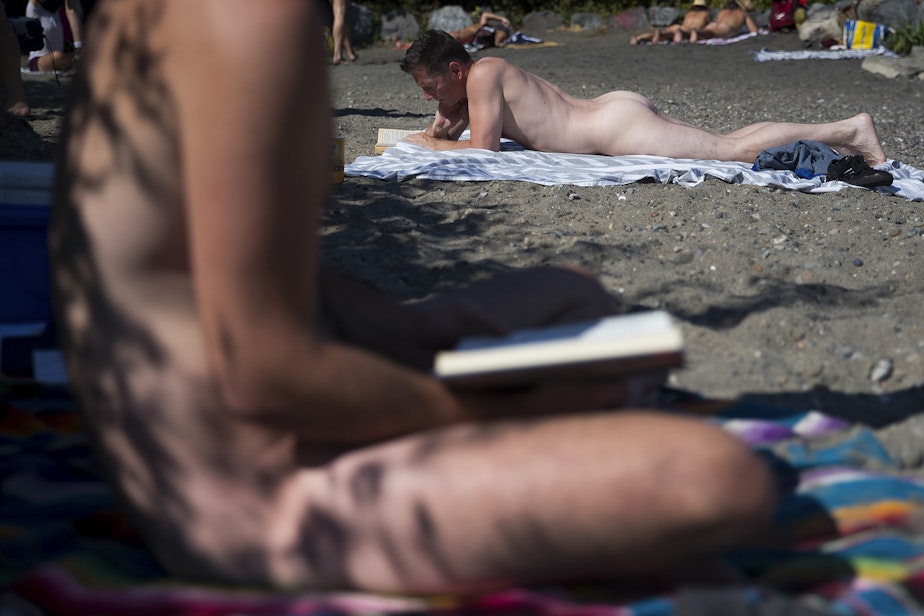 caption: Beachgoers read on Monday, August 27, 2018, at Denny Blaine Park in Seattle. 