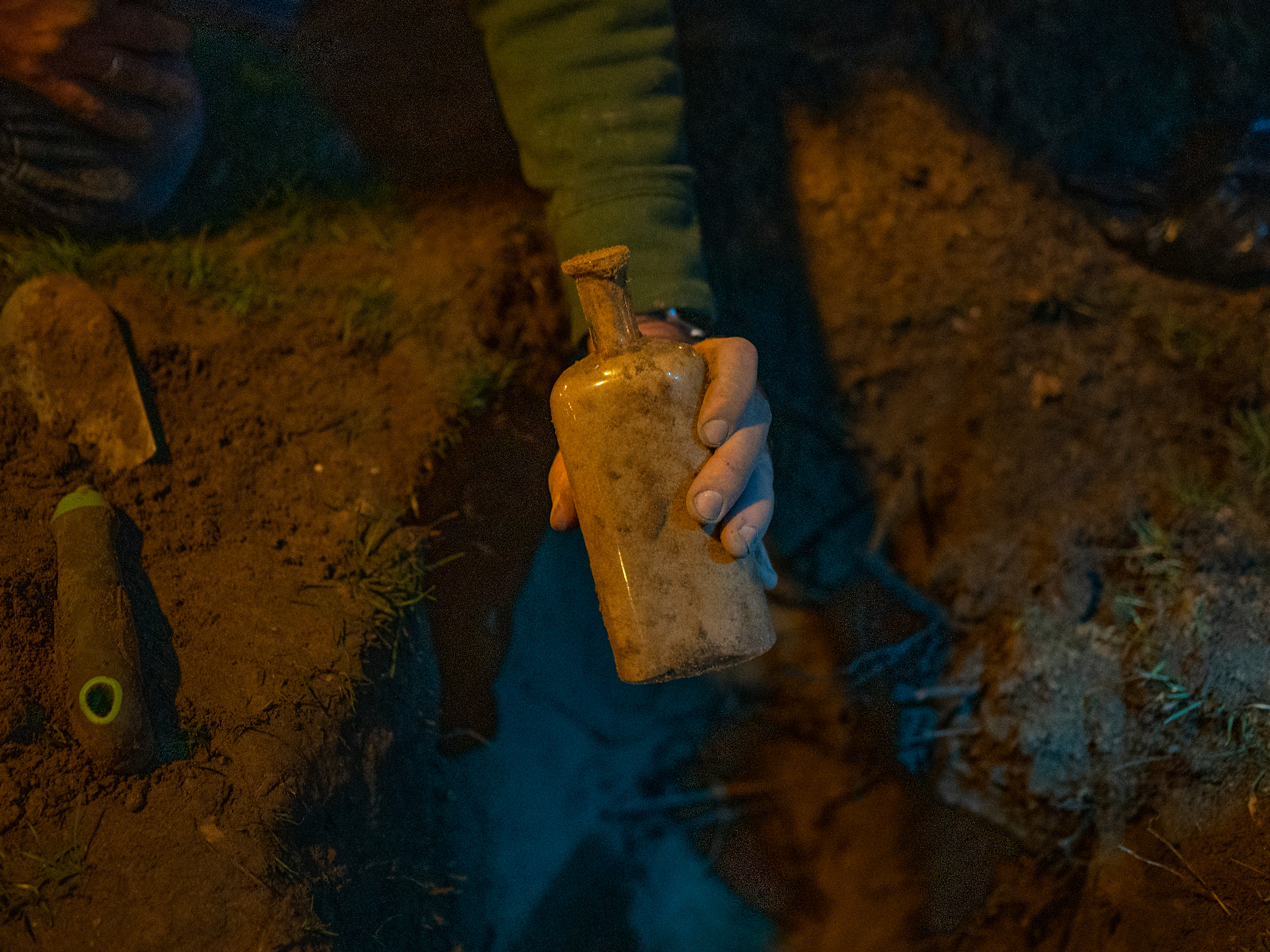 caption: Researchers search for a bottle filled with seeds that was buried 142 years ago as part of a seed germination study.