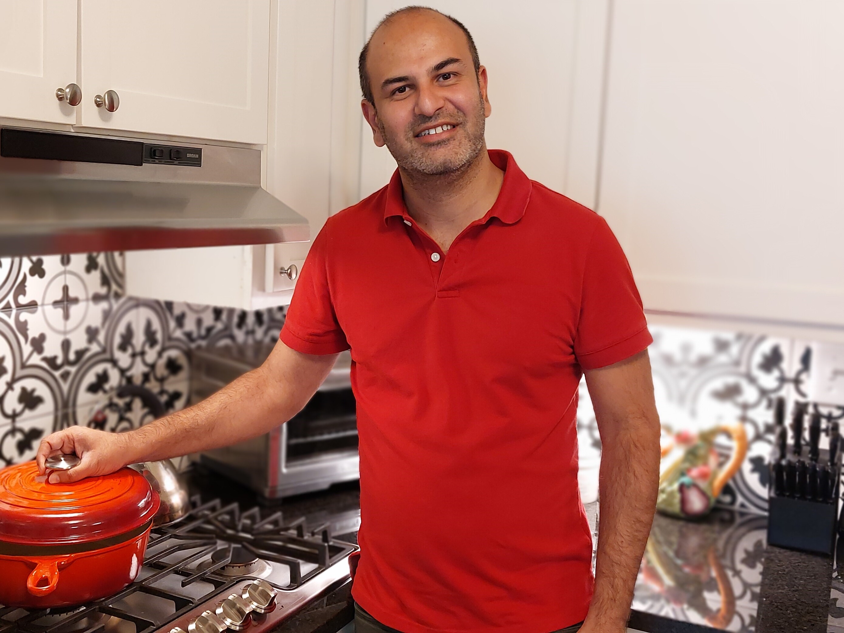 caption: KD Deshmukh says he recently celebrated his spouse's birthday with a salmon dinner at home. He also buys in bulk, clips coupons and has switched to more store brands to save money at the grocery store.