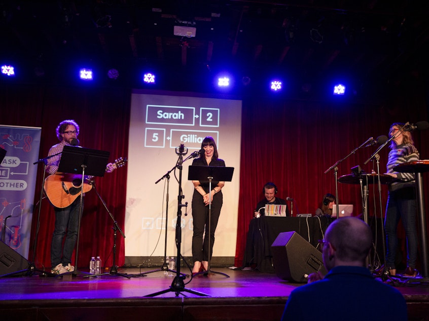 caption: Jonathan Coulton leads a music parody game on <em>Ask Me Another</em> at the Bell House in Brooklyn, New York.