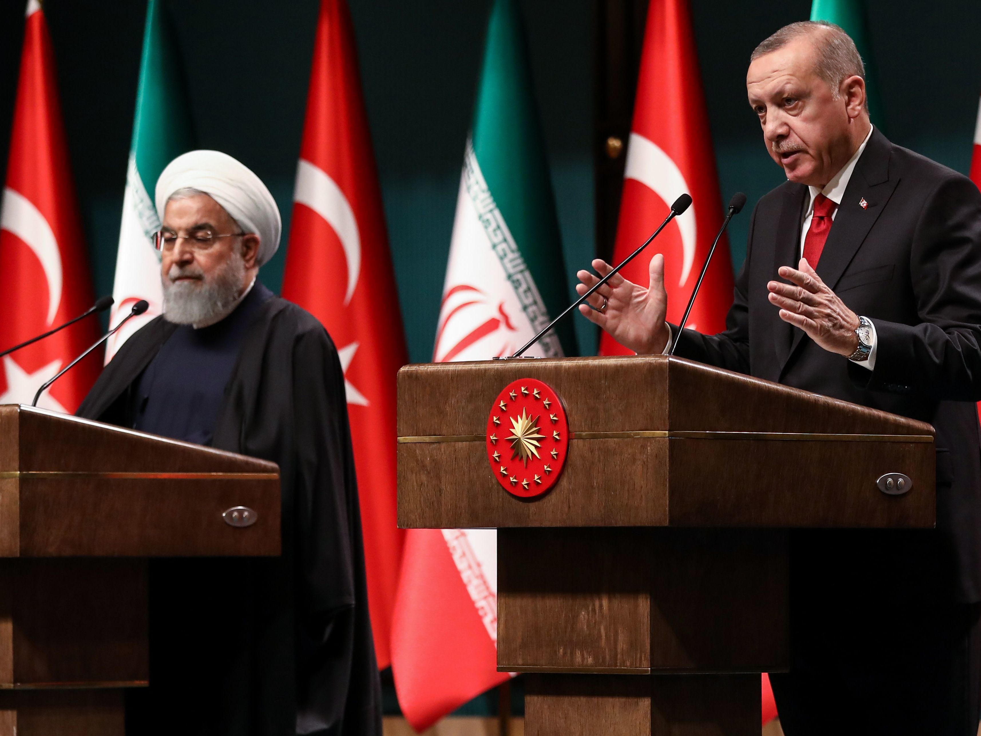 caption: Iranian President Hassan Rouhani (left) and Turkish President Recep Tayyip Erdogan address a joint news conference Thursday in Ankara. The pair of leaders asserted their partnership in Syria after the U.S. announced its withdrawal.