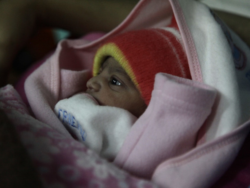 caption: A 5-pound newborn girl is swaddled in a blanket in a hospital in Islamabad, Pakistan. She was born on Jan. 1, 2020.