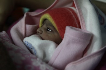 caption: A 5-pound newborn girl is swaddled in a blanket in a hospital in Islamabad, Pakistan. She was born on Jan. 1, 2020.