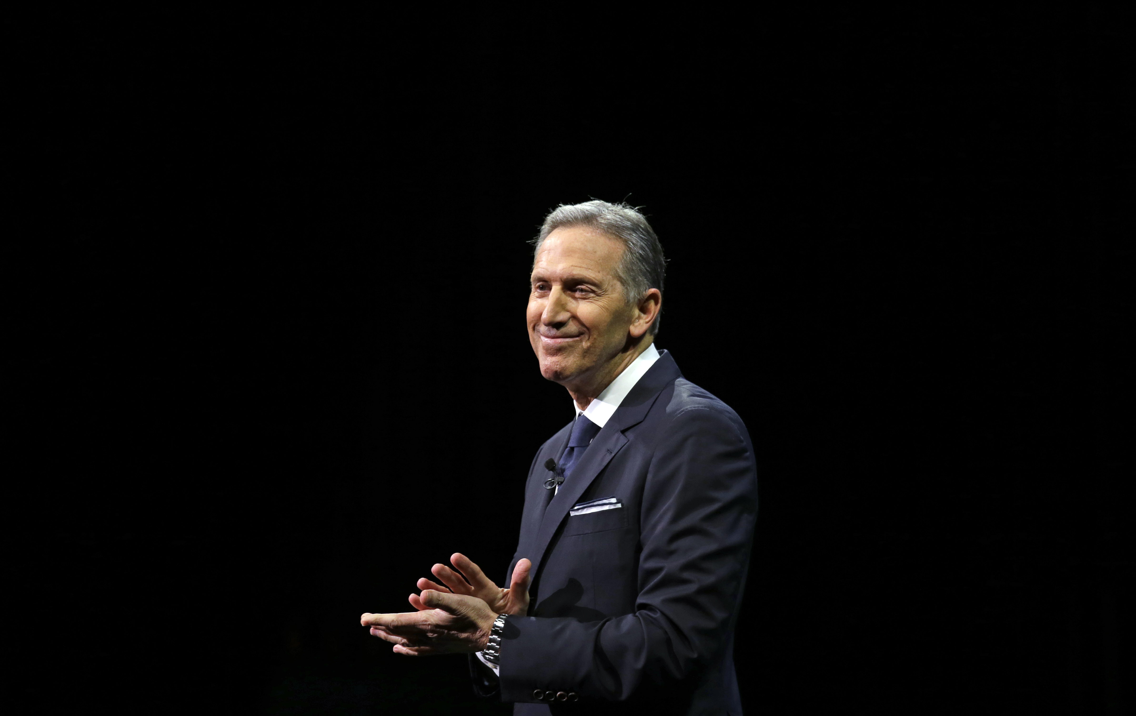 caption: FILE: Starbucks CEO Howard Schultz pauses as he speaks to applaud employees at the Starbucks annual shareholders meeting Wednesday, March 22, 2017, in Seattle. 