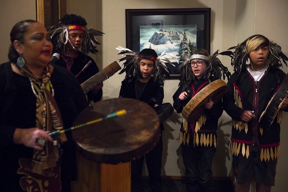 caption: The Lummi Blackhawk Singers sing the Lummi national anthem on Wednesday December 5, 2018, before the fisher release at the North Cascades Visitor Center in Newhalem.