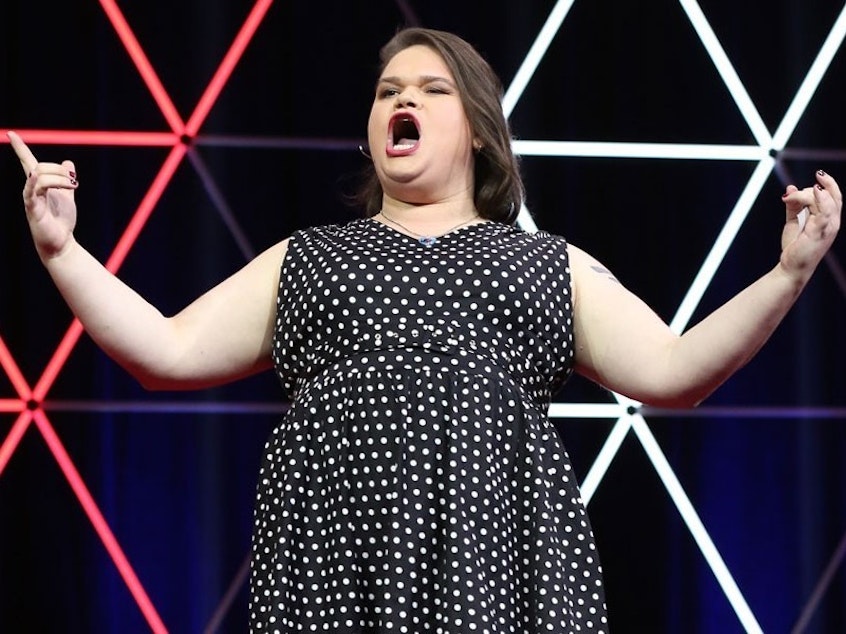 caption: Jordan Raskopoulos on the TED stage.