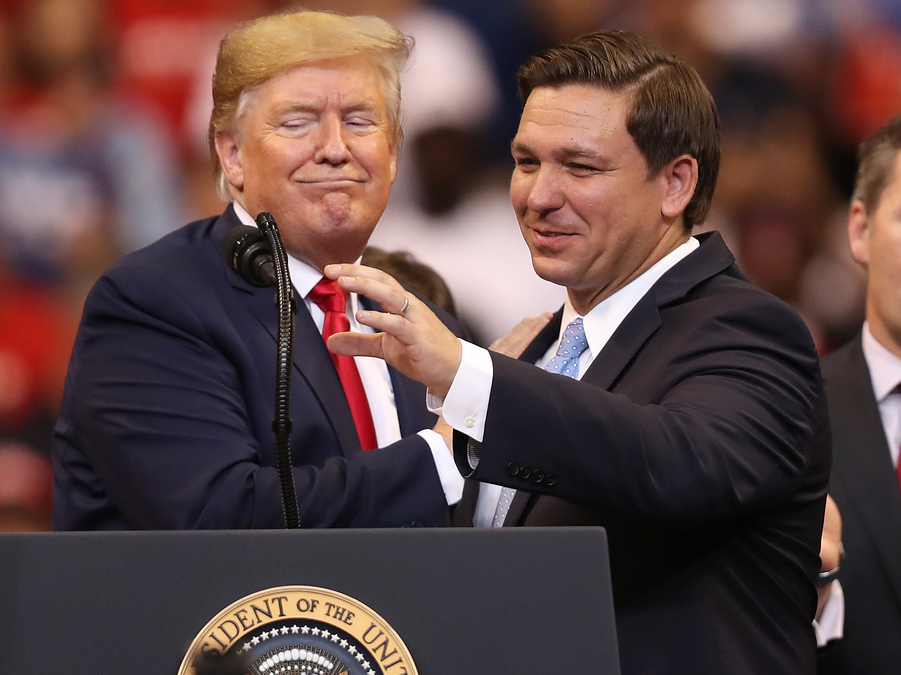 caption: Seen in happier days: Trump helped DeSantis win a tough GOP primary for governor in 2018 and was still an ally when the two appeared together in 2019 in Sunrise, Fla.