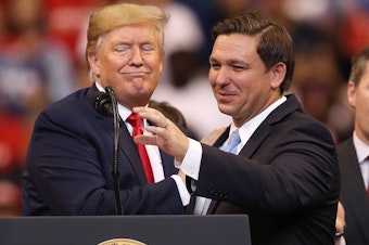 caption: Seen in happier days: Trump helped DeSantis win a tough GOP primary for governor in 2018 and was still an ally when the two appeared together in 2019 in Sunrise, Fla.