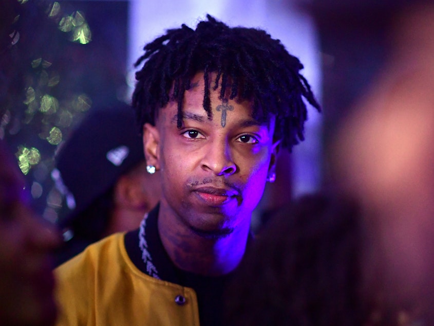 caption: Rapper 21 Savage attends an event related to his new album, "I Am > I Was," in Atlanta. The rapper, whose real name is Sha Yaa Bin Abraham-Joseph, was arrested Sunday by U.S. Immigration and Customs Enforcement.