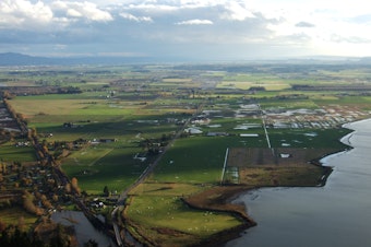 caption: Conversations with farmers in the Skagit Valley, seen here from Samish Overlook, inspired a Democratic state legislator to propose to bar foreign entities from buying Washington croplands.