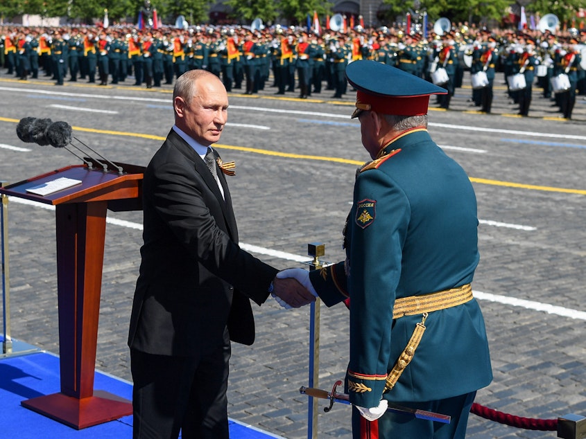 caption: Russian President Vladimir Putin and Defense Minister Sergei Shoigu shake hands at this month's Victory Day military parade marking the 75th anniversary of Nazi Germany's defeat in World War II.