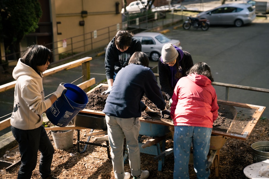 caption: Volunteers process compost for Restaurant 2 Garden, a community composting initiative in Seattle's Chinatown International District. 