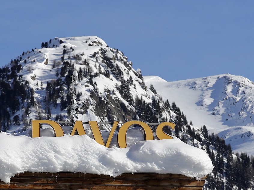 caption: A Davos sign sits atop a hotel roof ahead of this year's World Economic Forum in Davos, Switzerland.