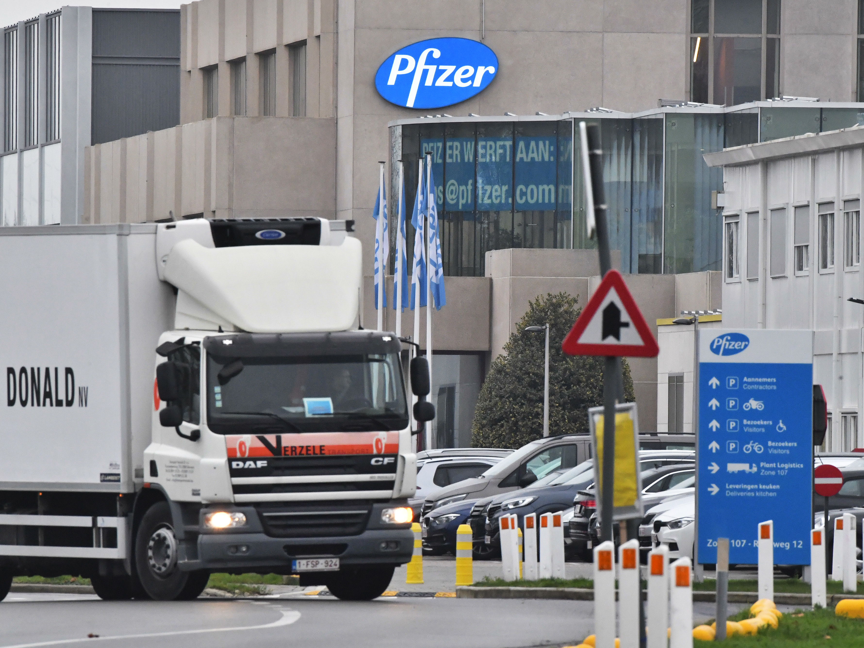 caption: The U.K. will begin a mass vaccination against COVID-19 on Tuesday, as hundreds of thousands of doses of Pfizer's vaccine reach the public. Here, a temperature-controlled cold storage truck leaves a Pfizer facility in Belgium Thursday.