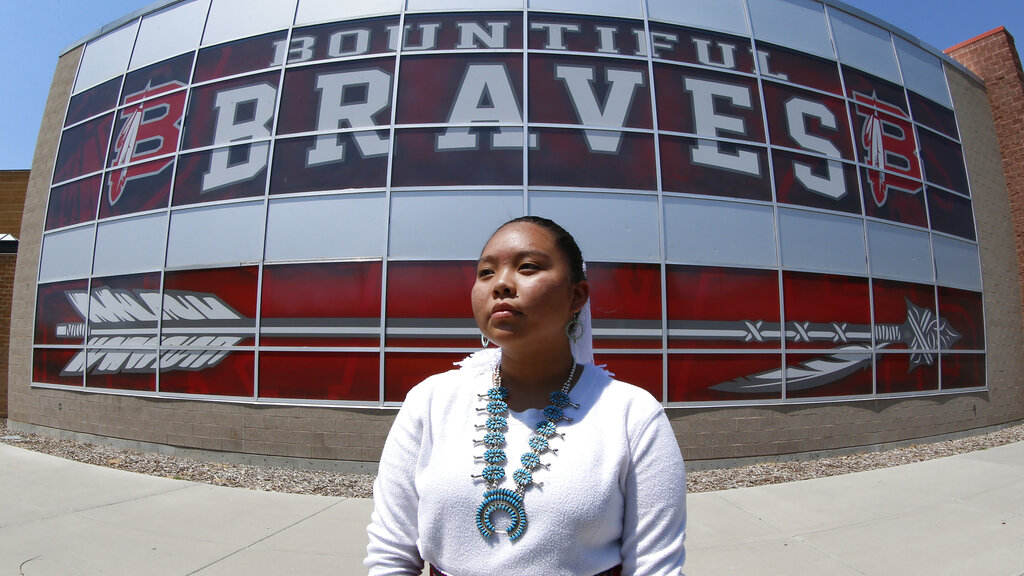 caption: Lemiley Lane, a junior who grew up in the Navajo Nation in Arizona, poses for a photograph at Bountiful High School in Bountiful, Utah, July 21, 2020. A primarily white high school near Salt Lake City began replacing its hotly-contested Braves mascot after nearly 70 years. 