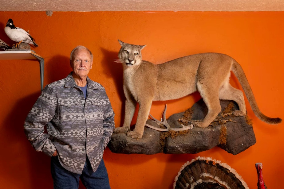 caption: Former Wildlife Services employee Carter Niemeyer displays some of his taxidermy handiwork in his garage in Boise, Idaho.