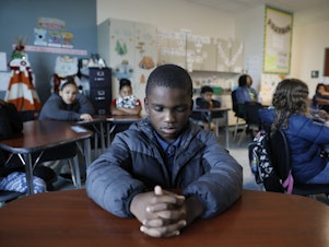 caption: A student named Royce closes his eyes during a mindfulness session in class at Patricia J. Sullivan Partnership School in Tampa, Fla. Students say the daily lessons help them cope with their feelings.